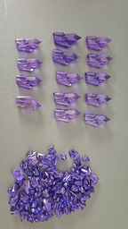 Collection of purple crystal points on a light gray background